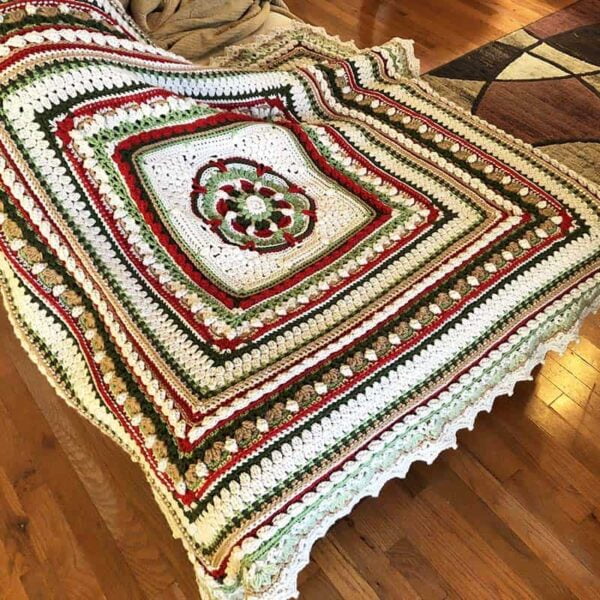 Shades of green, cranberry, toasted almond square blanket